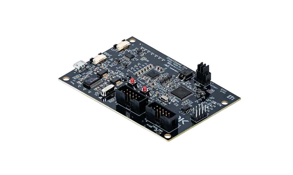 Black PCB with various chips and circuits