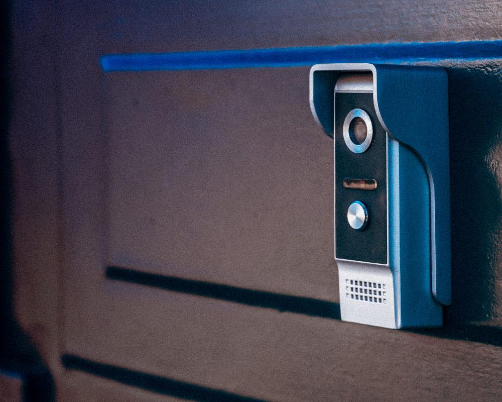 Close-up photo of a smart doorbell on the door of a home