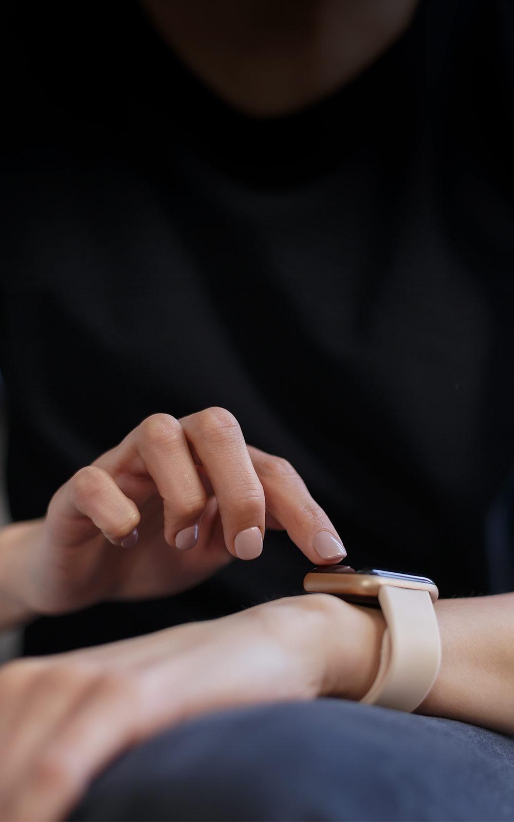 Photo of someone interacting with their smart watch