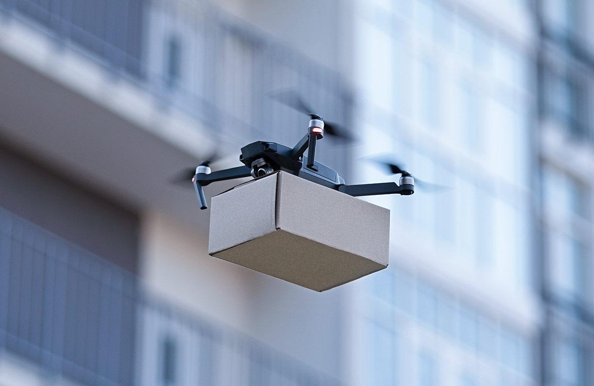 Drone carrying a package in a residential complex