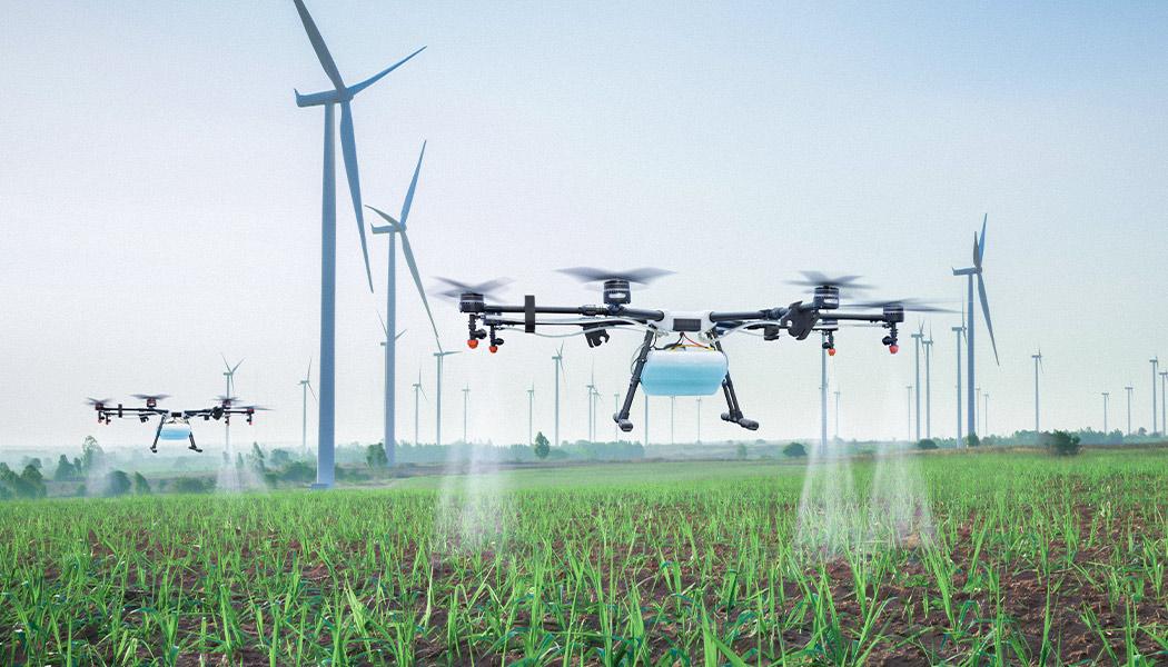 Photo of agriculture drone spraying fields as it flies