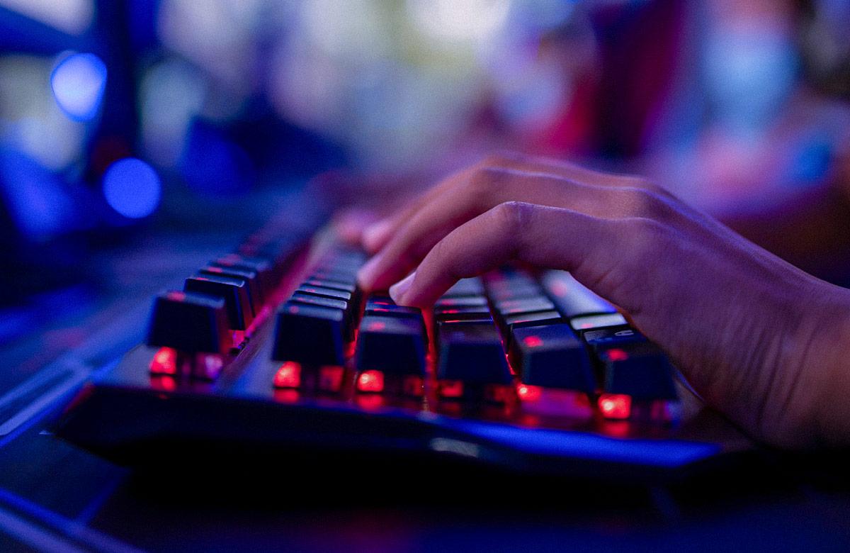 Close-up photograph of a hand using a gaming keyboard