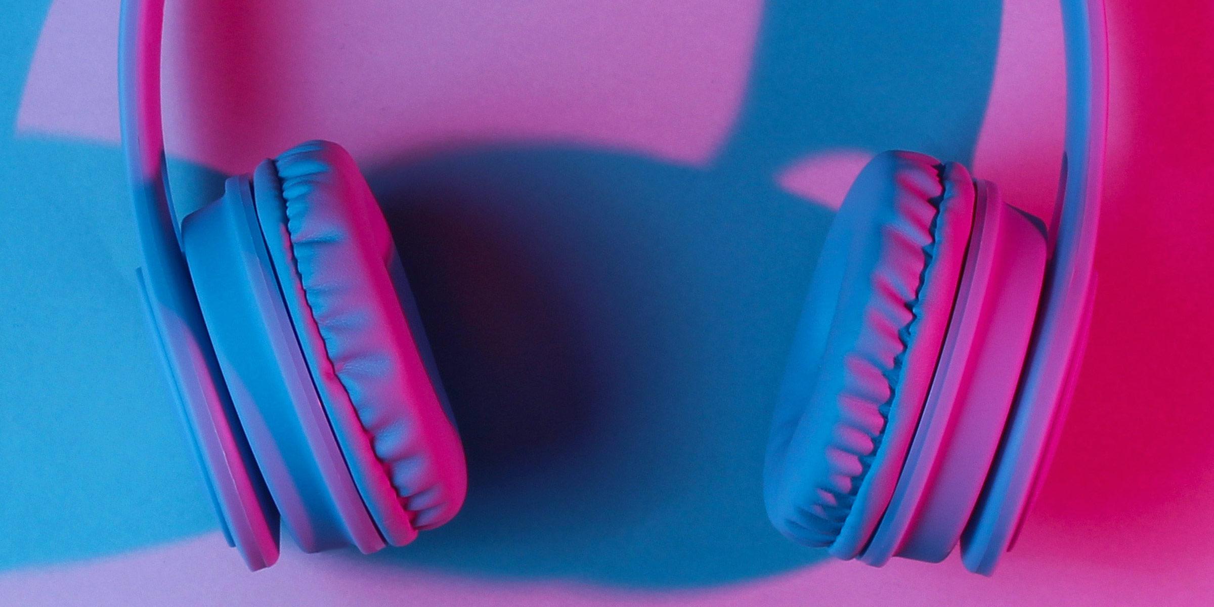 Close up photograph of over-ear headphones with a blue and pink overlay