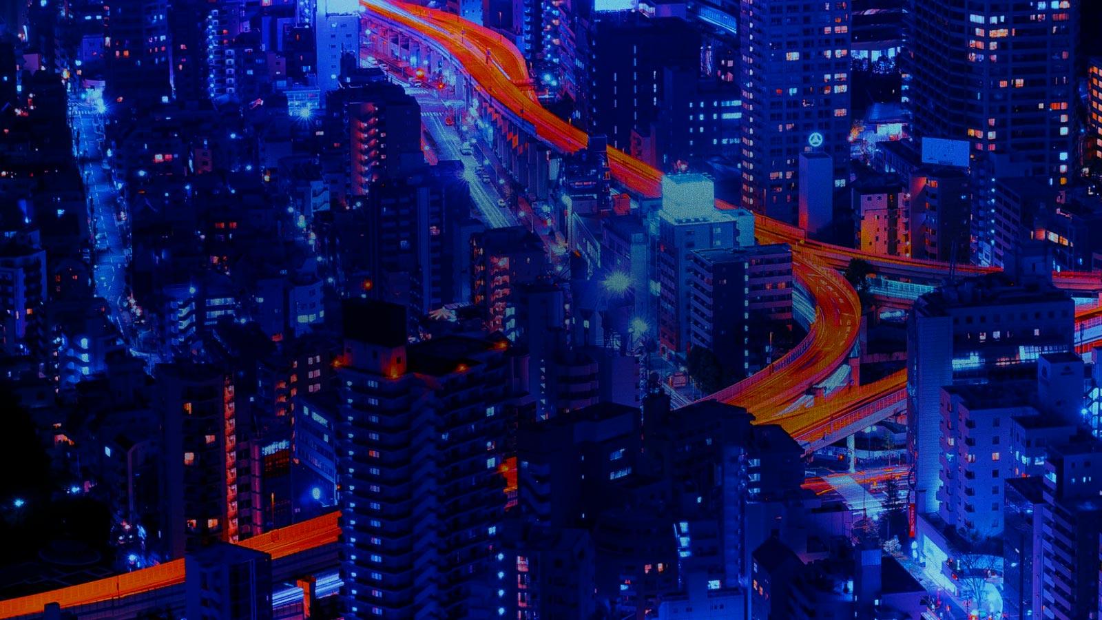 Aerial view of city with streaks of light left by bustling traffic