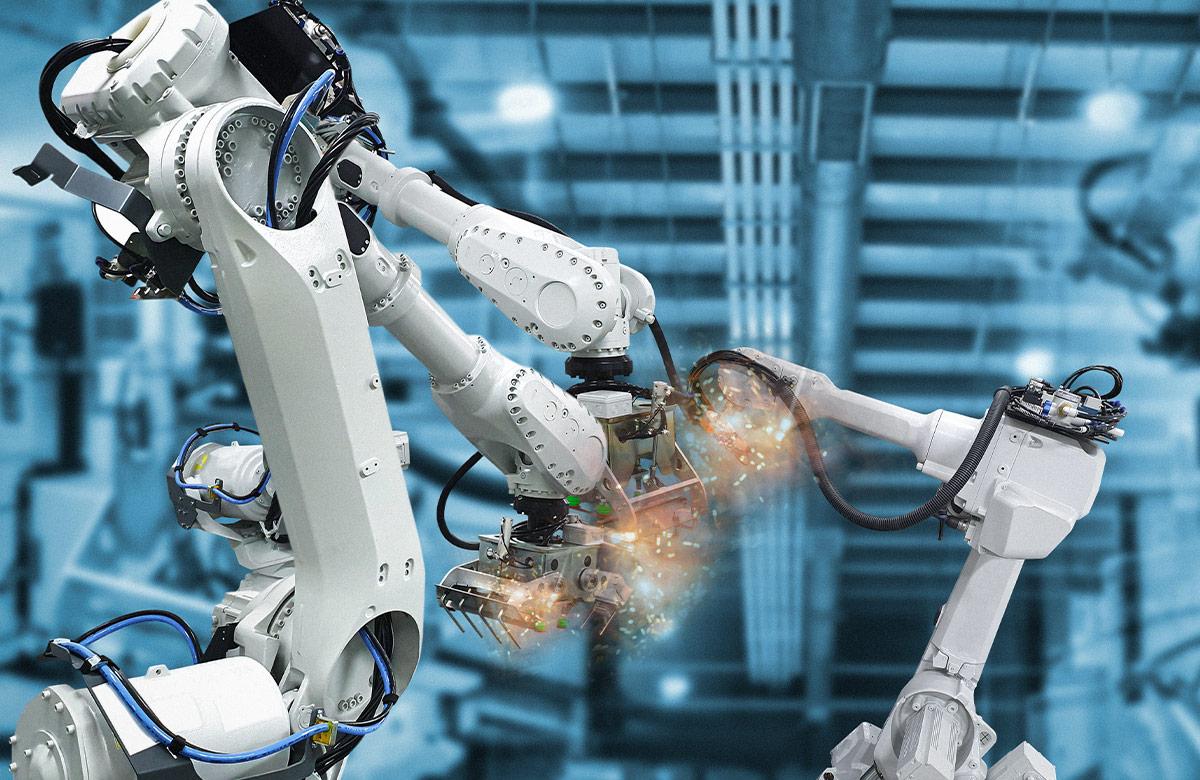 Photograph of a series of robotic arms in a manufacturing facility