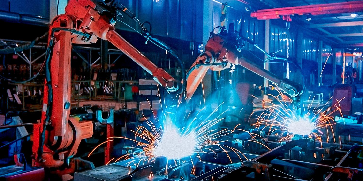 Large factory robotic arms working in a warehouse and creating sparks