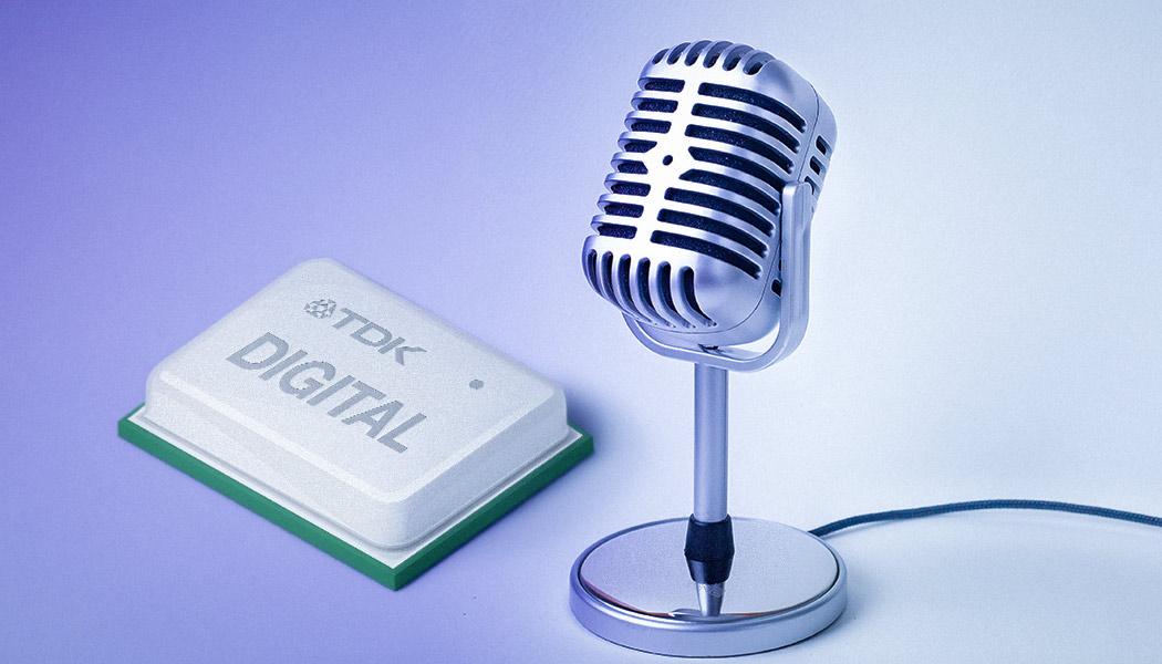 An enlarged TDK microchip next to a classic microphone