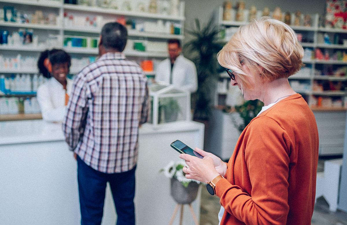 Photograph of patients waiting in line at a pharmacy or clinic