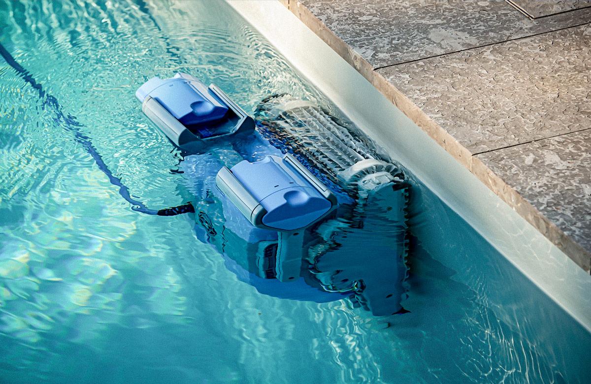 Photograph of a pool cleaner robot operating inside of a swimming pool