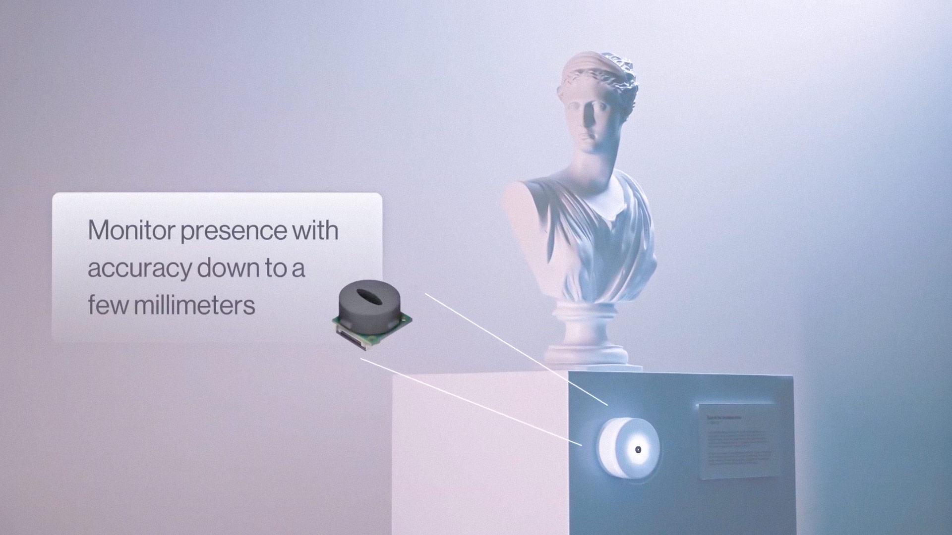 Photograph of a statue on a pedestal with an illuminated device attached to it. A call-out with the text "Monitor presence with accuracy down to a few millimeters"