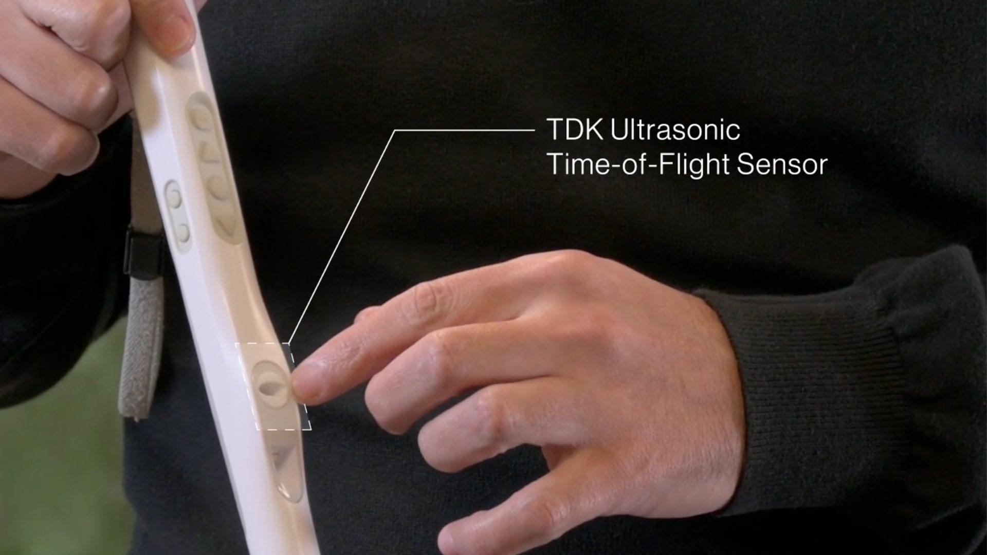 Close-up photograph of the handle of a tech-enabled white cane for visually impaired people