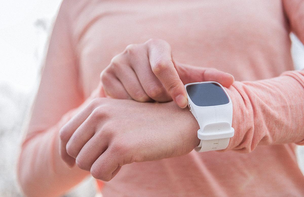 Woman in exercise outfit using smart watch