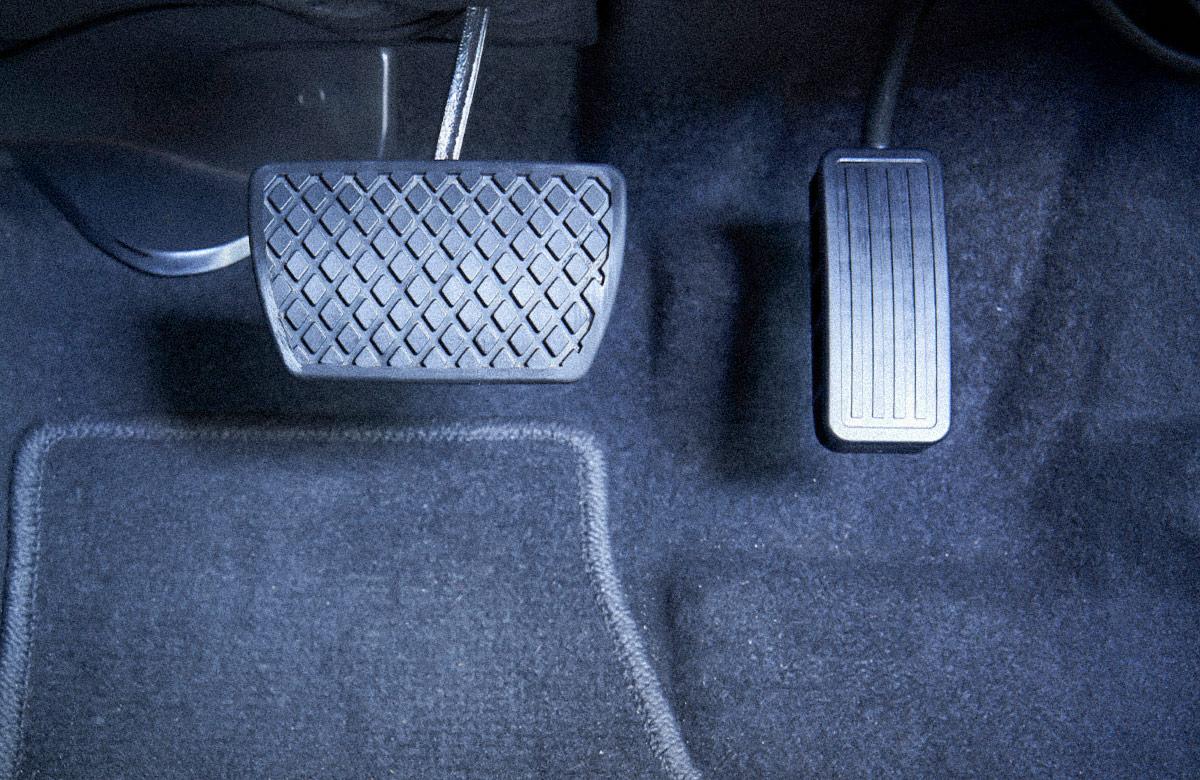 Close-up on brake and accelerator pedals in an automatic transmission car