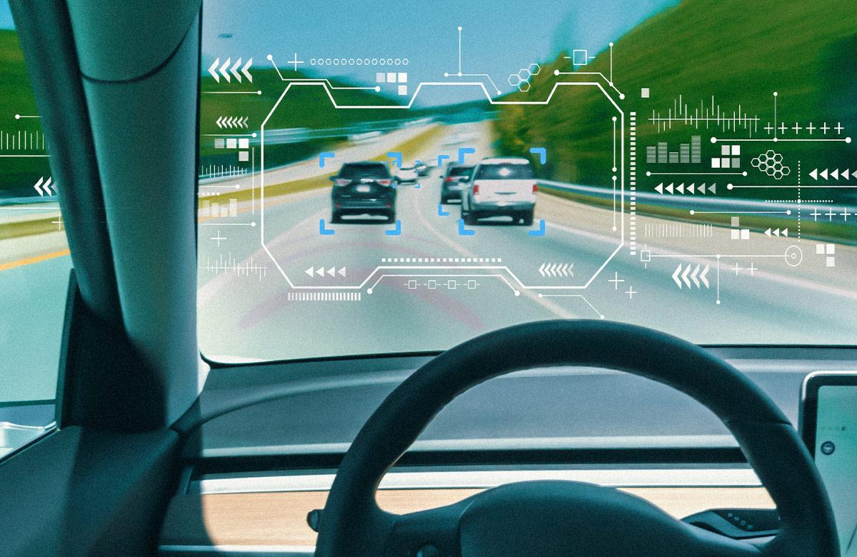 Driver’s POV looking over steering wheel to virtual display overlay on traffic ahead