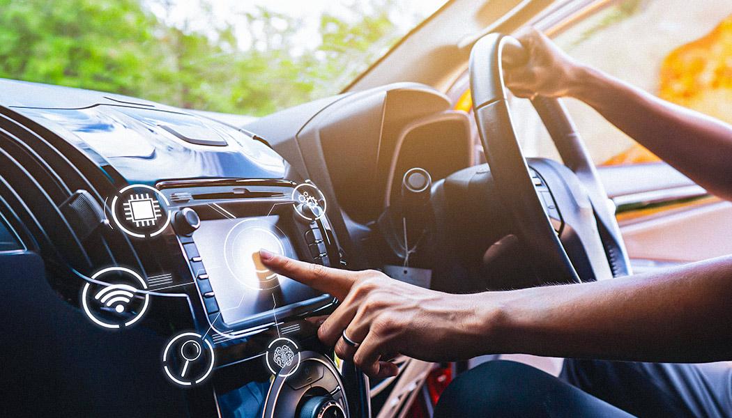 Vehicle interior, driver interacting with car infotainment system, with overlays of various tech icons