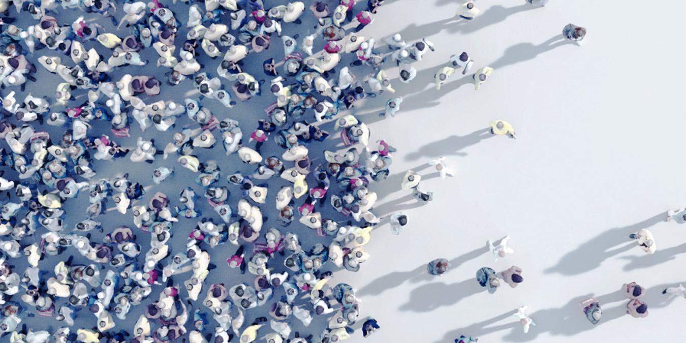 Aerial view of a crowded group of people that becomes less crowded toward the right side of the image