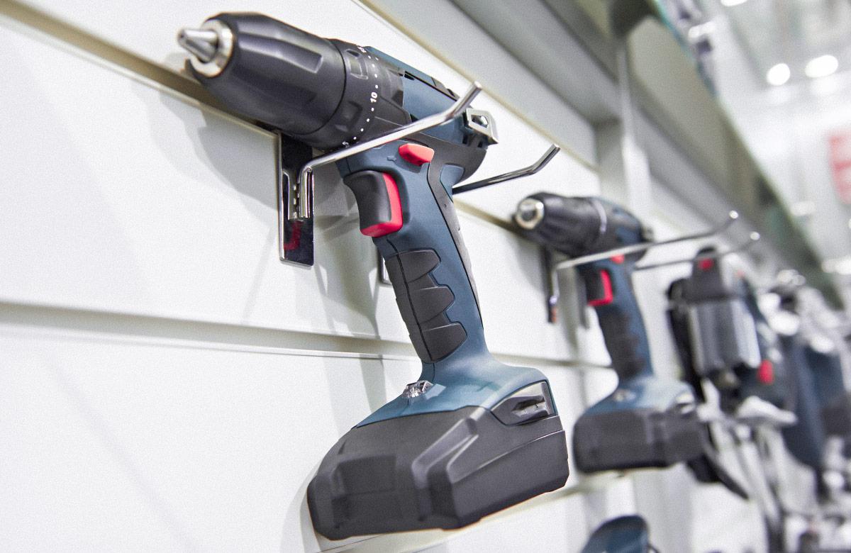 Green and black electric screwdriver for construction on wall mounted display in shop