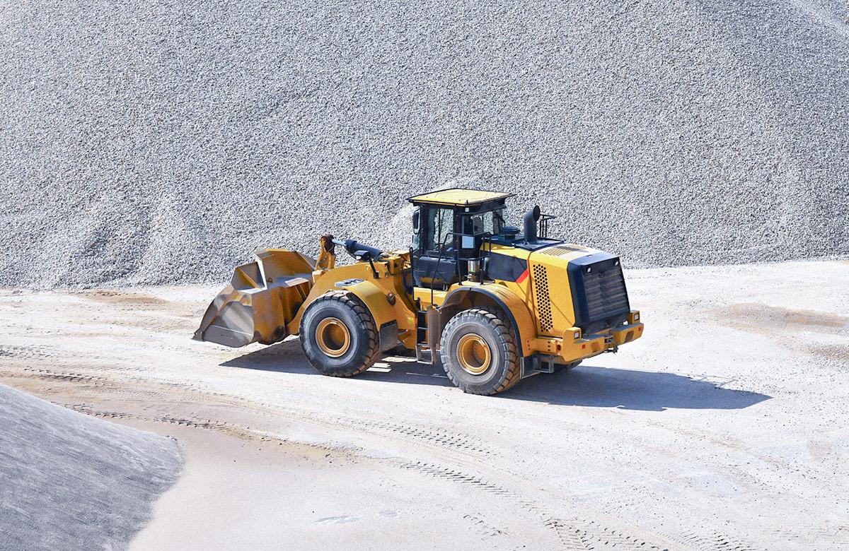 Heavy construction machine operating in a large gravel pit