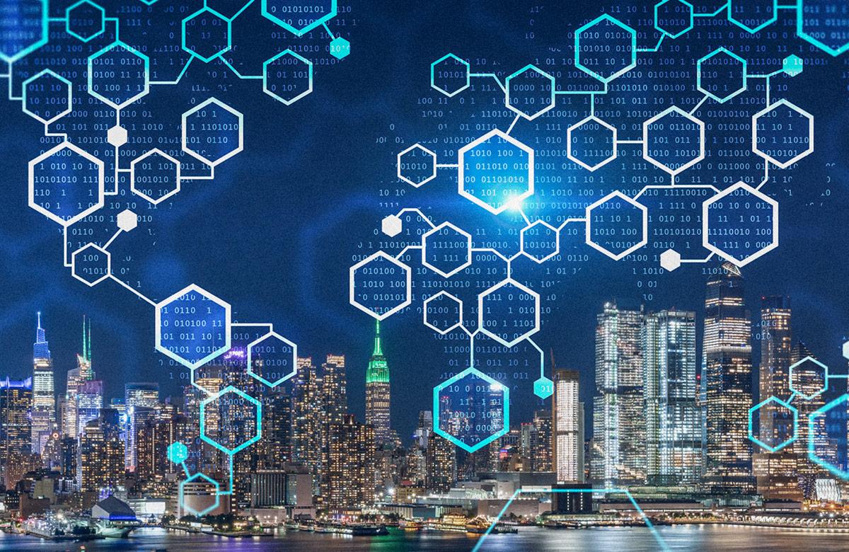 Night cityscape featuring a waterfront view of lit skyscrapers with embedded digital hexagonal overlay, with white and cyan hexagonal shapes and binary code in a data cloud formation.