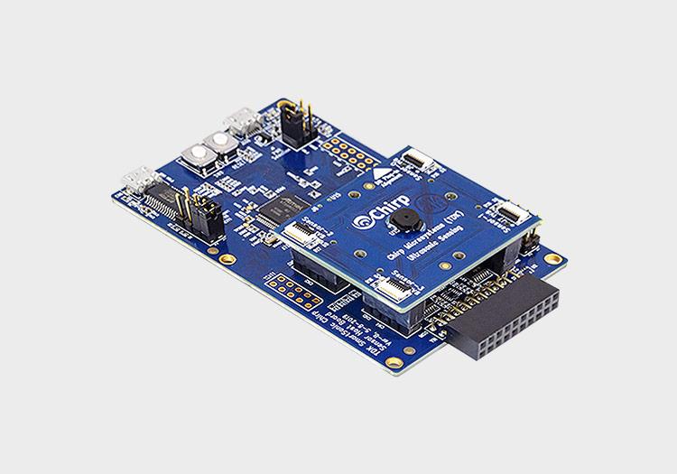 DK-CH101: Two PCBs stacked together with many small chips and components attached to them