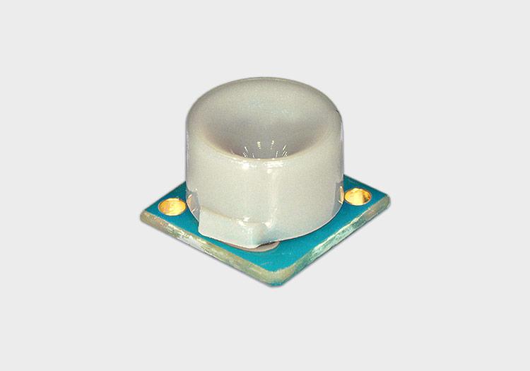 Small green circuit board with white acoustic horn attached